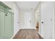 Bright hallway featuring stylish wood-look flooring, white doors, and modern wall accents at 6853 Kellum Dr, Indianapolis, IN 46221