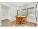 Cozy breakfast nook with natural light, wooden table set, and a view of the backyard at 6853 Kellum Dr, Indianapolis, IN 46221