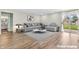 Staged living room features modern decor, plush seating, and sliding glass doors for indoor-outdoor living at 6853 Kellum Dr, Indianapolis, IN 46221