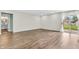 Bright living room featuring wood floors, white walls and a sliding glass door leading to an outdoor patio at 6853 Kellum Dr, Indianapolis, IN 46221