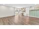 Spacious living room featuring wood flooring, neutral walls, and a sliding glass door to the backyard at 6853 Kellum Dr, Indianapolis, IN 46221