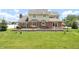 This backyard features two patios, a green lawn, and a sprawling two story home at 7082 Hunters Ridge Dr, Plainfield, IN 46168