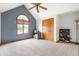 A charming bedroom with vaulted ceiling, a fan, large window, and wood closet doors at 7082 Hunters Ridge Dr, Plainfield, IN 46168