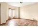 Bright bedroom with hardwood floors, a large window and neutral paint colors at 7082 Hunters Ridge Dr, Plainfield, IN 46168