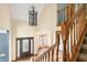 A beautiful entryway with hardwood floors and an ornate wrought iron chandelier at 7082 Hunters Ridge Dr, Plainfield, IN 46168