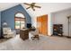 A stylish home office featuring vaulted ceiling, fan, built-in bookcase and window with view at 7082 Hunters Ridge Dr, Plainfield, IN 46168