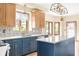 Kitchen featuring a center island with wood and blue cabinets and stone countertops at 7082 Hunters Ridge Dr, Plainfield, IN 46168