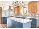 A sleek kitchen featuring an island, stainless appliances and designer backsplash at 7082 Hunters Ridge Dr, Plainfield, IN 46168