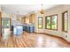 A modern kitchen with wood floors, an island and two toned cabinets with stone counter tops at 7082 Hunters Ridge Dr, Plainfield, IN 46168