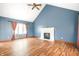 Spacious living room with vaulted ceiling, fireplace, and hardwood floors at 7082 Hunters Ridge Dr, Plainfield, IN 46168