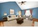Cozy living room with vaulted ceiling, fireplace, and comfortable seating area at 7082 Hunters Ridge Dr, Plainfield, IN 46168