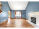 Spacious living room with fireplace, hardwood floors, and lots of natural light at 7082 Hunters Ridge Dr, Plainfield, IN 46168