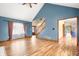 Bright and open living room with hardwood floors, fireplace, and access to the foyer at 7082 Hunters Ridge Dr, Plainfield, IN 46168
