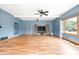Living room area with hardwood floors, a ceiling fan, and natural light at 7082 Hunters Ridge Dr, Plainfield, IN 46168