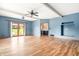 Spacious living room with hardwood floors, a ceiling fan, and natural light at 7082 Hunters Ridge Dr, Plainfield, IN 46168