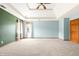 A spacious main bedroom with a tray ceiling, fan, and neutral carpet at 7082 Hunters Ridge Dr, Plainfield, IN 46168