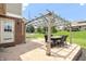 This outdoor patio features a dining table, brick facade and sprawling backyard at 7082 Hunters Ridge Dr, Plainfield, IN 46168