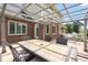 This covered patio features a brick facade, outdoor dining and a hammock at 7082 Hunters Ridge Dr, Plainfield, IN 46168