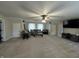 Large bonus room with plenty of space, featuring carpet, TV, and a ceiling fan at 7195 W 700 N, Fairland, IN 46126
