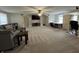 Expansive carpeted bonus room with a seating area, desk, and built-in shelving at 7195 W 700 N, Fairland, IN 46126