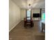 Charming dining room with wood floors, rustic table, and bright light fixture at 7195 W 700 N, Fairland, IN 46126