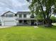 Charming two-story home with a well-manicured lawn and a welcoming front porch perfect for relaxing at 7195 W 700 N, Fairland, IN 46126