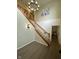 Welcoming foyer featuring hardwood floors, a staircase with wooden banister, and decorative lighting at 7195 W 700 N, Fairland, IN 46126