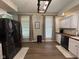Bright eat-in kitchen featuring a dark refrigerator, white cabinets, wooden countertops, and natural light at 7195 W 700 N, Fairland, IN 46126