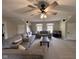 Large living room with couches, a ceiling fan, and abundant natural light from dual windows at 7195 W 700 N, Fairland, IN 46126