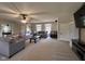 Large living room with couches, a ceiling fan, and abundant natural light from dual windows at 7195 W 700 N, Fairland, IN 46126