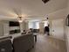 Bright living room with a ceiling fan, carpeting, built-in shelves, and a workspace at 7195 W 700 N, Fairland, IN 46126
