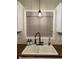 Close-up of a kitchen sink featuring wooden countertops, white cabinets, and modern fixtures at 7195 W 700 N, Fairland, IN 46126