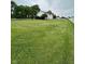 Spacious and well-maintained green lawn with a charming white fence bordering the property at 7195 W 700 N, Fairland, IN 46126