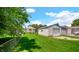 View of the backyard with detached garage and well-maintained lawn at 753 Walnut St, Franklin, IN 46131