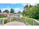 A serene backyard view with a deck overlooking the well-manicured lawn and detached garage at 753 Walnut St, Franklin, IN 46131