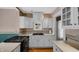 Updated kitchen with white cabinets, black sink, stainless steel appliances, and a gas cooktop at 753 Walnut St, Franklin, IN 46131