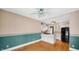 Large kitchen with hardwood floors, white cabinets, and a black refrigerator at 753 Walnut St, Franklin, IN 46131