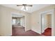 Spacious living room showing classic wallpaper, soft carpet, and multiple doorways at 753 Walnut St, Franklin, IN 46131