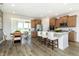Bright, open kitchen featuring a spacious island, stainless steel appliances, and eat-in dining area at 7601 Bluegill Dr, Noblesville, IN 46062