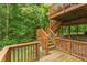 View of the wood deck and stairs leading down to the lush backyard area at 7818 Fawnwood Dr, Indianapolis, IN 46278