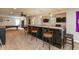 Finished basement featuring a bar with granite countertops, seating and two televisions at 7818 Fawnwood Dr, Indianapolis, IN 46278
