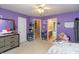 Bedroom with lavender walls, closet, dresser, ceiling fan, and ensuite bathroom at 7818 Fawnwood Dr, Indianapolis, IN 46278