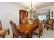 Formal dining area featuring a large wooden table and views into other living spaces at 7818 Fawnwood Dr, Indianapolis, IN 46278