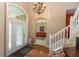 Welcoming foyer with hardwood floors, chandelier, staircase, and views into the living spaces at 7818 Fawnwood Dr, Indianapolis, IN 46278
