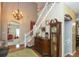 Grand foyer featuring a staircase, chandelier, wood floors, and antique decor accents at 7818 Fawnwood Dr, Indianapolis, IN 46278