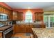Spacious kitchen with stone countertops, stainless steel appliances, and a large window at 7818 Fawnwood Dr, Indianapolis, IN 46278