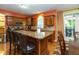 Eat-in kitchen with center island and seating, stainless appliances, stone countertops, and access to the patio at 7818 Fawnwood Dr, Indianapolis, IN 46278