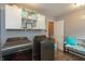 Bright laundry room featuring modern washer and dryer, upper cabinets, and tiled floor at 7818 Fawnwood Dr, Indianapolis, IN 46278