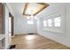 Dining room with wood floors, natural light, and decorative lighting fixture at 909 N Parker Ave, Indianapolis, IN 46201
