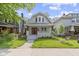 Charming two-story home featuring a well-maintained lawn and inviting front porch at 909 N Parker Ave, Indianapolis, IN 46201